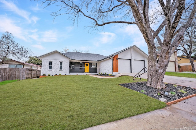 view of front of house with a garage, a front yard, and covered porch