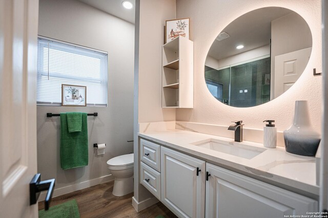 bathroom featuring vanity, hardwood / wood-style flooring, a shower, and toilet