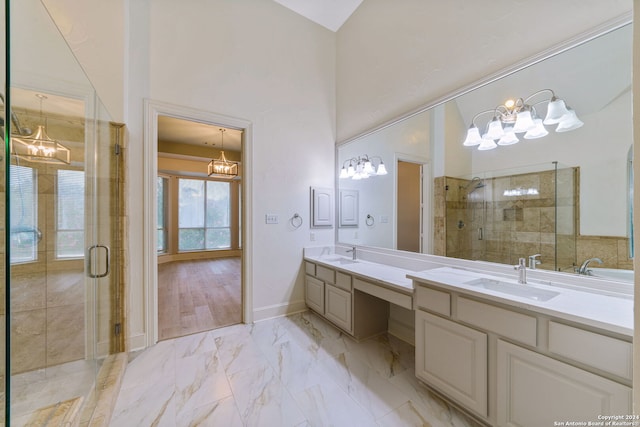 bathroom featuring vanity, an enclosed shower, and a chandelier