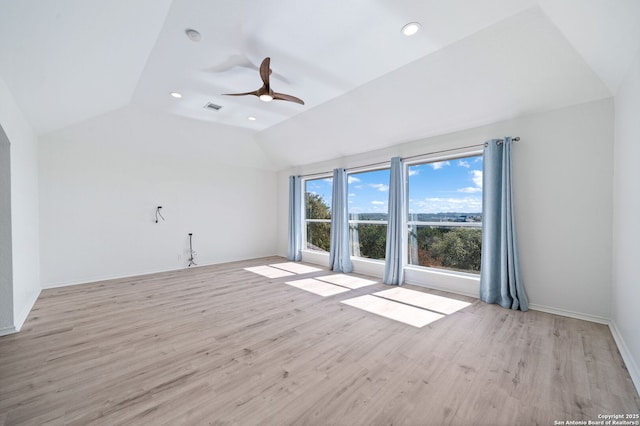 unfurnished room featuring ceiling fan, vaulted ceiling, and light wood-type flooring