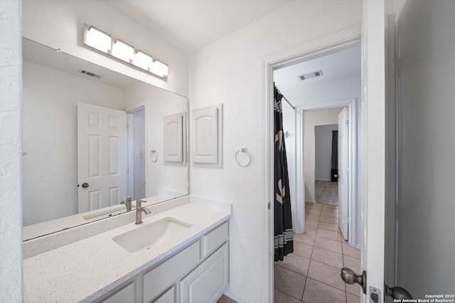 bathroom with vanity and tile patterned flooring