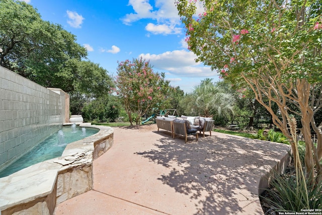 view of patio / terrace featuring a playground and an outdoor hangout area