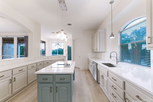 kitchen with sink, hanging light fixtures, black electric stovetop, a kitchen island, and stainless steel dishwasher