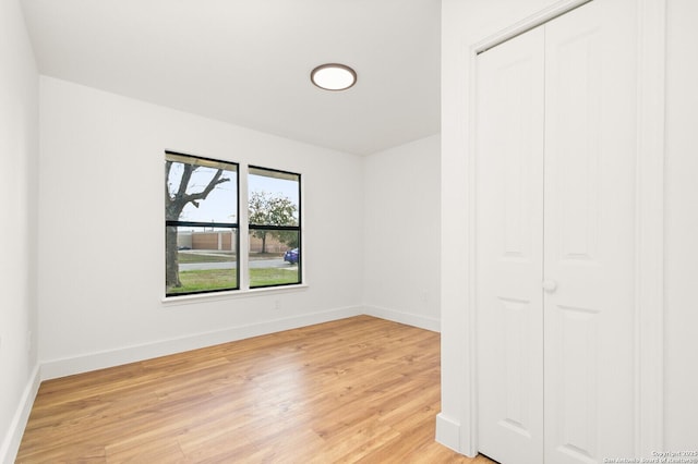 unfurnished bedroom featuring hardwood / wood-style flooring and a closet