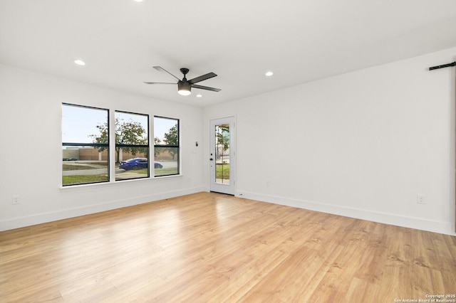 empty room featuring ceiling fan and light hardwood / wood-style flooring