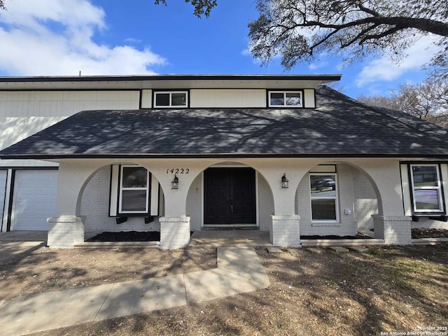 view of front of home with a garage and a porch