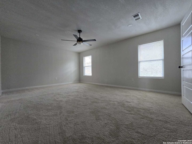 spare room with ceiling fan, carpet flooring, and a textured ceiling