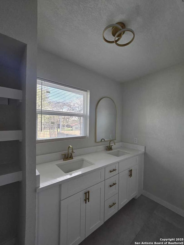 bathroom with vanity and a textured ceiling