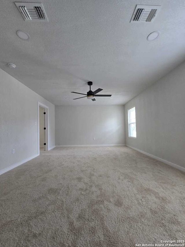 spare room with ceiling fan, carpet floors, and a textured ceiling