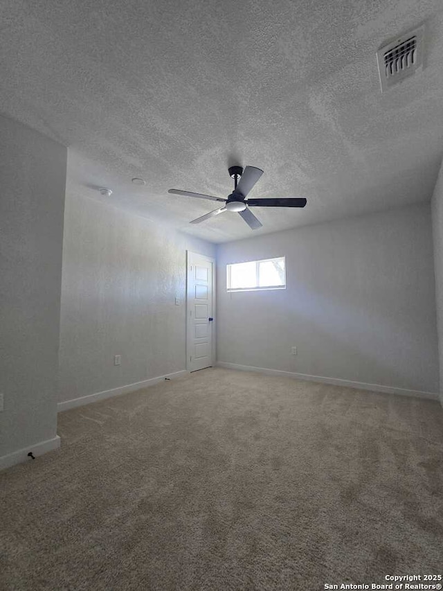 unfurnished room featuring a textured ceiling, ceiling fan, and carpet