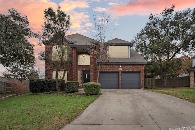 view of property featuring a garage and a lawn