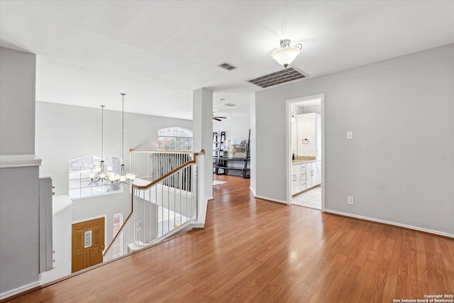 interior space with a chandelier and light hardwood / wood-style floors