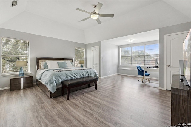 bedroom featuring wood-type flooring, lofted ceiling, and ceiling fan