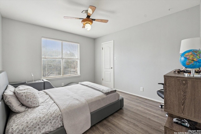 bedroom with dark hardwood / wood-style floors and ceiling fan