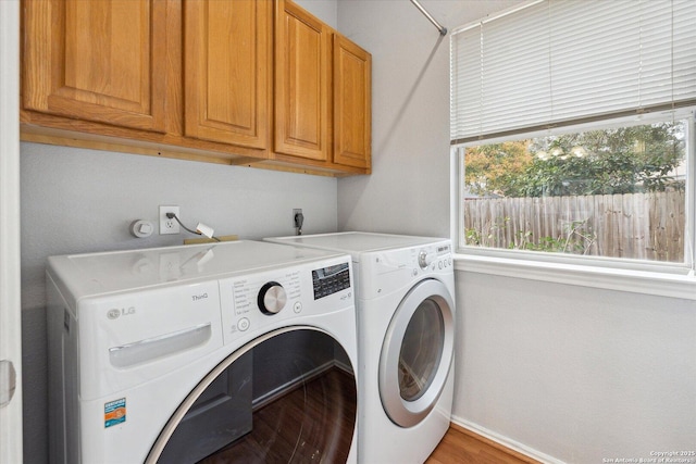 laundry room with cabinets, separate washer and dryer, and hardwood / wood-style floors