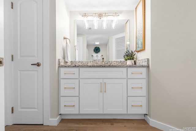 bathroom with vanity and hardwood / wood-style flooring