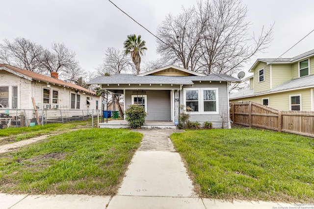 bungalow featuring a porch and a front lawn