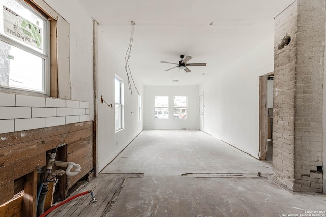 unfurnished living room featuring ceiling fan