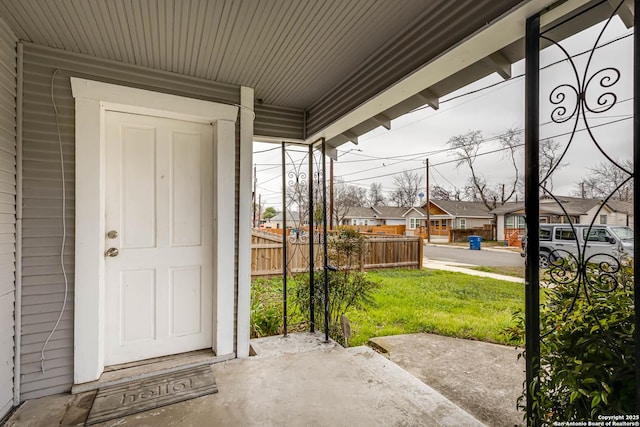 doorway to property with a lawn