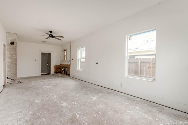 unfurnished living room with ceiling fan