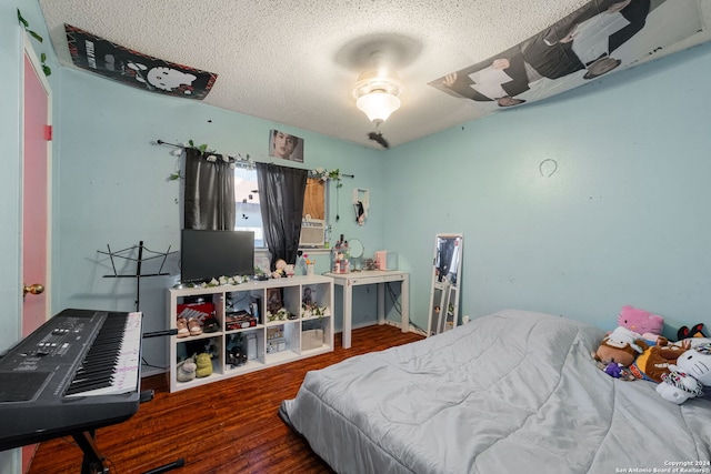 bedroom with dark hardwood / wood-style flooring and a textured ceiling