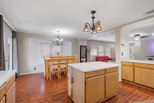 kitchen with a center island, plenty of natural light, dark hardwood / wood-style flooring, a notable chandelier, and pendant lighting