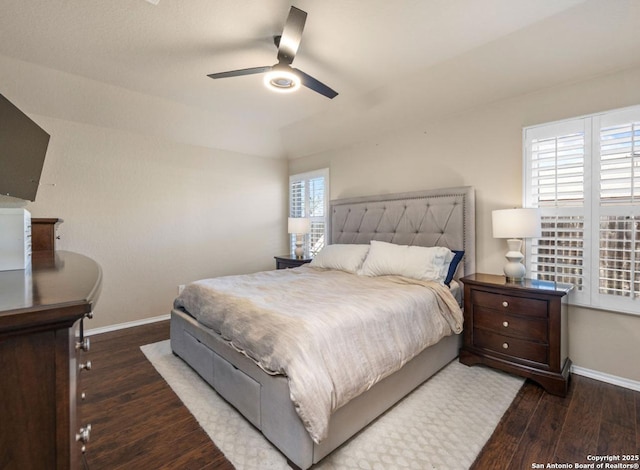 bedroom with ceiling fan and dark hardwood / wood-style floors