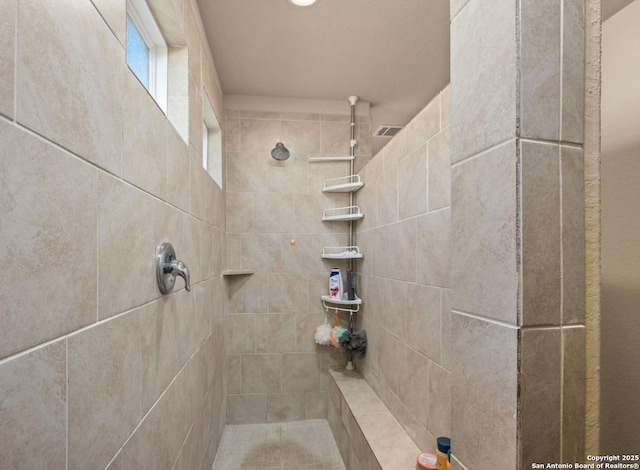 bathroom featuring tiled shower