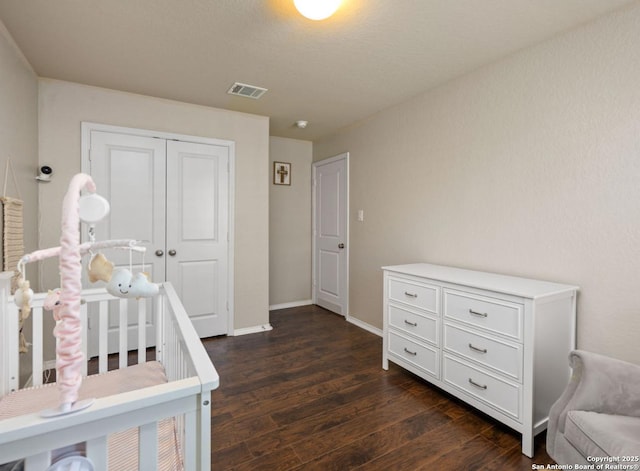 bedroom featuring dark wood-type flooring and a closet