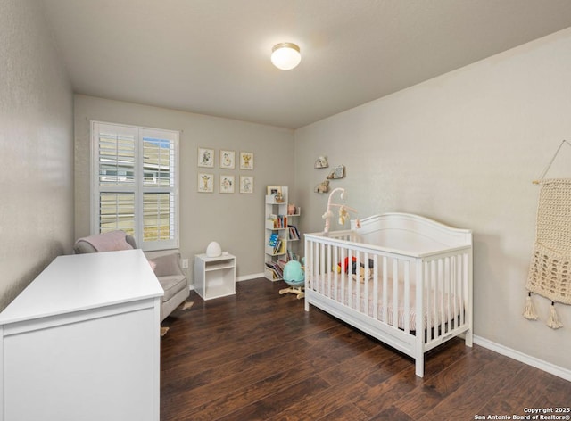 bedroom featuring dark hardwood / wood-style flooring and a nursery area