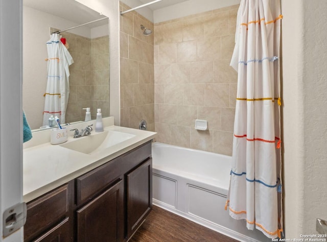 bathroom with shower / tub combo with curtain, vanity, and hardwood / wood-style flooring