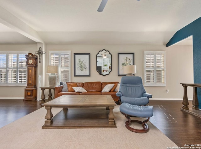 living room featuring vaulted ceiling, ceiling fan, and dark hardwood / wood-style flooring