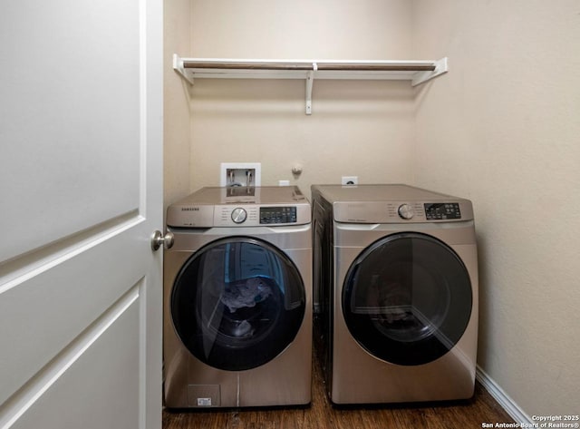 laundry room with dark wood-type flooring and washing machine and clothes dryer