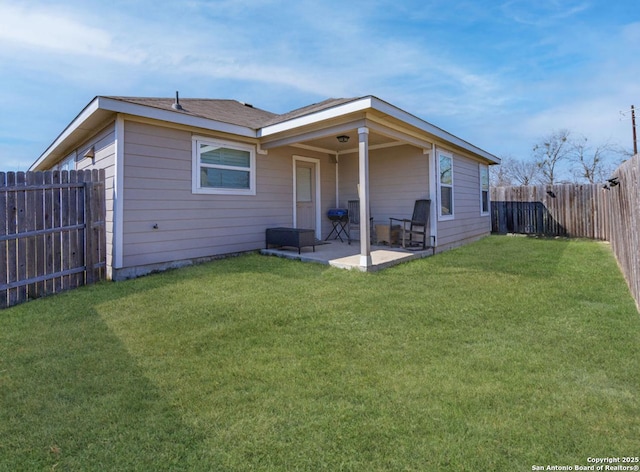 rear view of house featuring a yard and a patio area