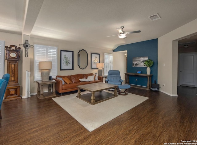 living room featuring ceiling fan and dark hardwood / wood-style flooring