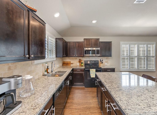 kitchen with dark brown cabinetry, sink, black appliances, light stone countertops, and backsplash