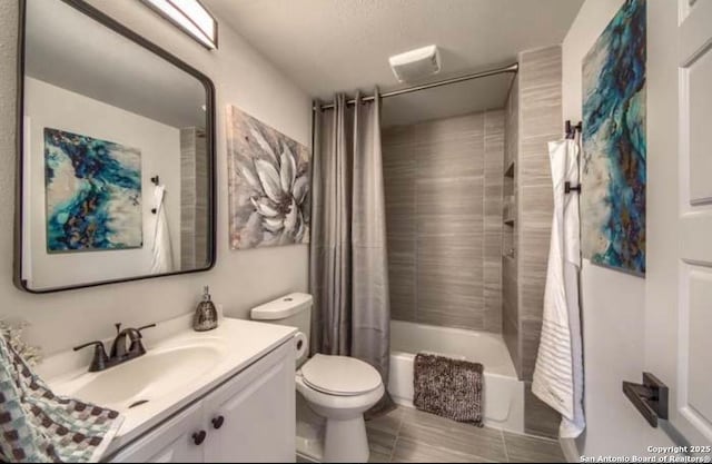 full bathroom with toilet, tile patterned floors, vanity, and shower / bathtub combination with curtain