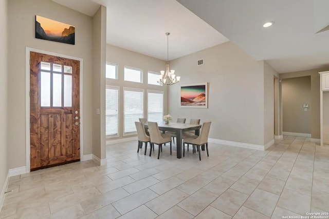 tiled dining room featuring an inviting chandelier