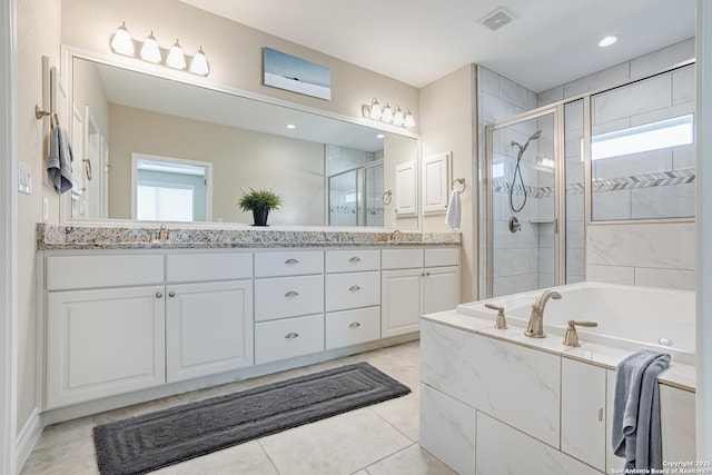 bathroom featuring plus walk in shower, vanity, and tile patterned floors