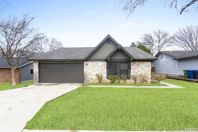 view of front of home with a garage and a front yard