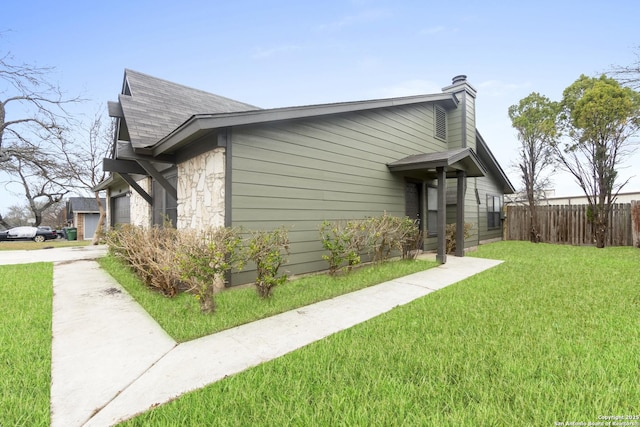 view of side of home with a lawn