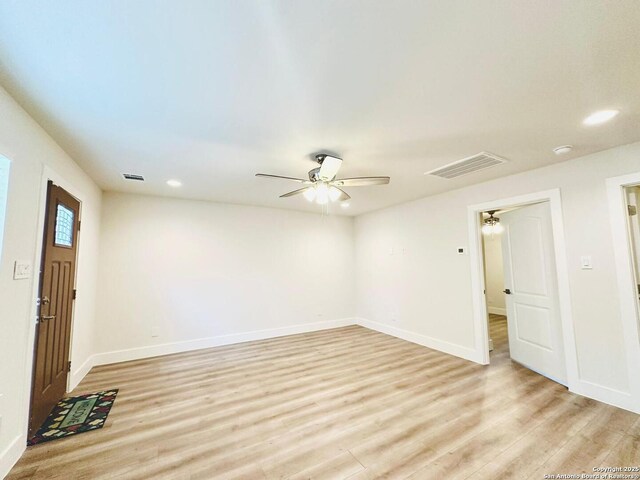 spare room featuring ceiling fan and light wood-type flooring