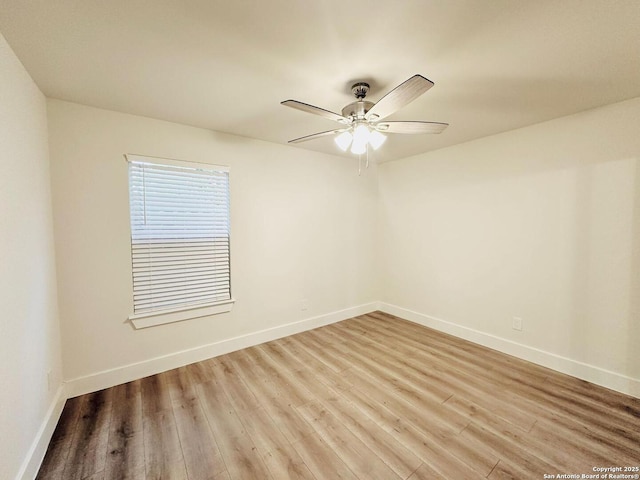 spare room with hardwood / wood-style flooring and ceiling fan