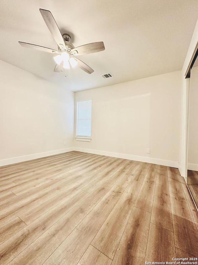 unfurnished room featuring ceiling fan and light wood-type flooring