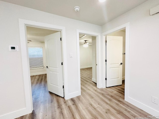 hallway with light hardwood / wood-style flooring