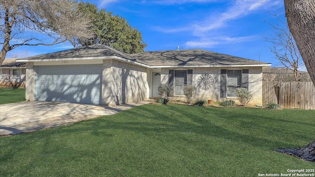 single story home featuring a garage and a front lawn