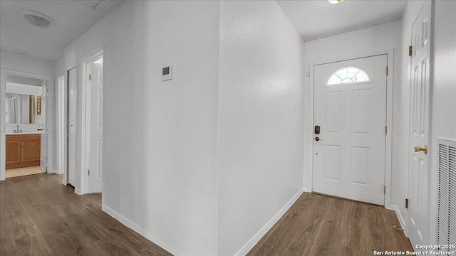 entryway with dark hardwood / wood-style floors