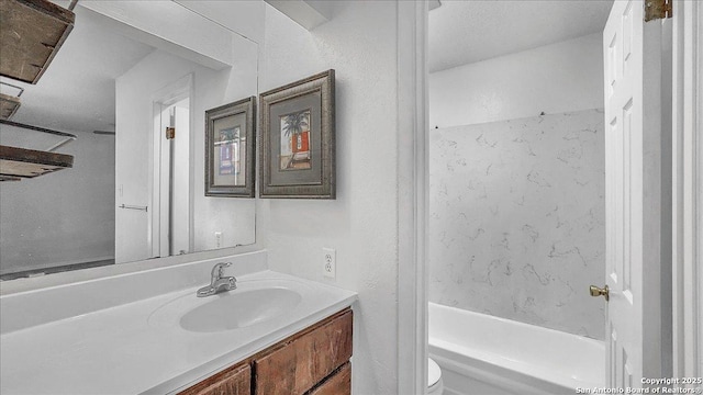 full bathroom featuring vanity, shower / washtub combination, and toilet