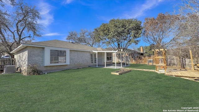 view of front of house featuring a front yard and central air condition unit