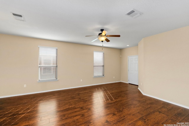 unfurnished room with ceiling fan and dark hardwood / wood-style flooring